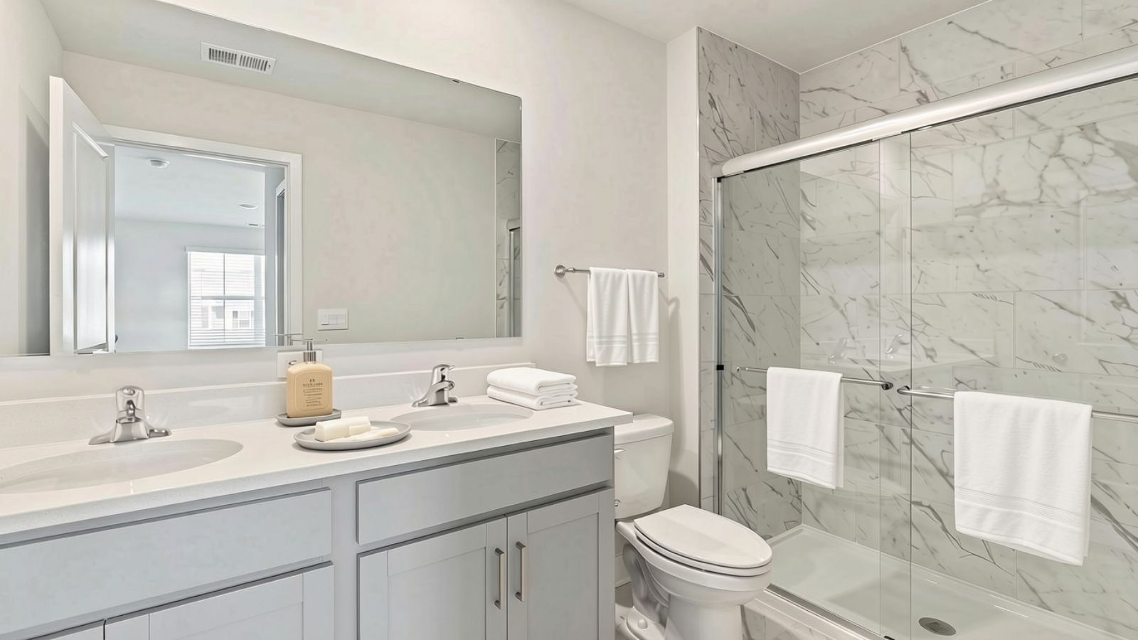 primary bathroom with dual sink vanity and walk in shower