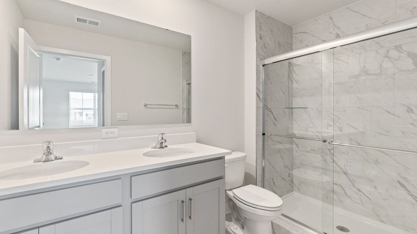 primary bathroom with dual sink vanity