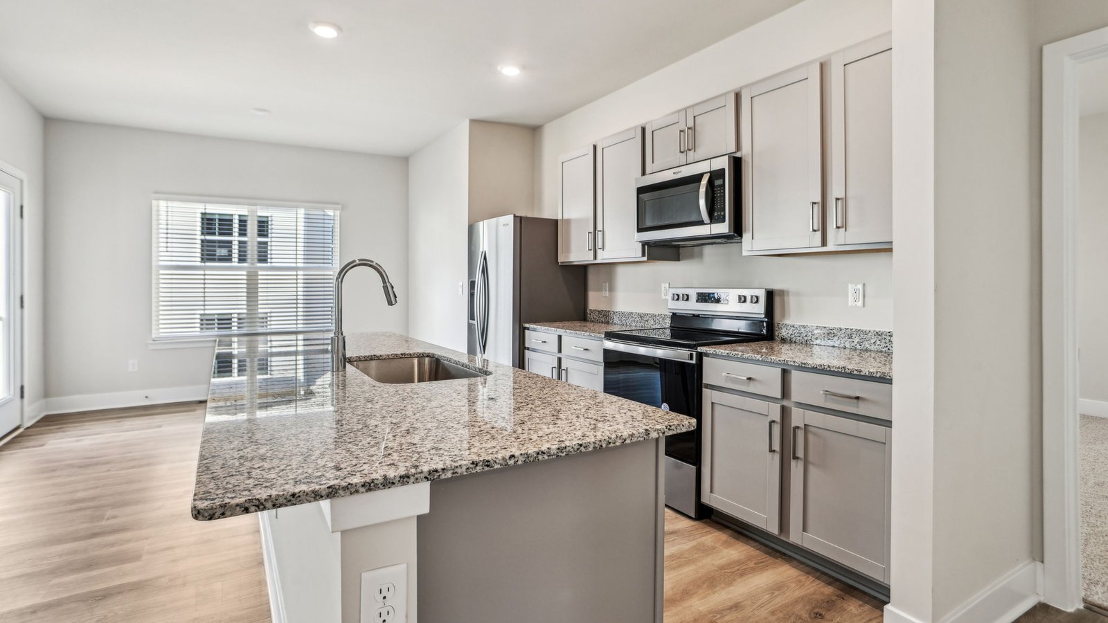 Kitchen has stainless steel appliances and granite countertops