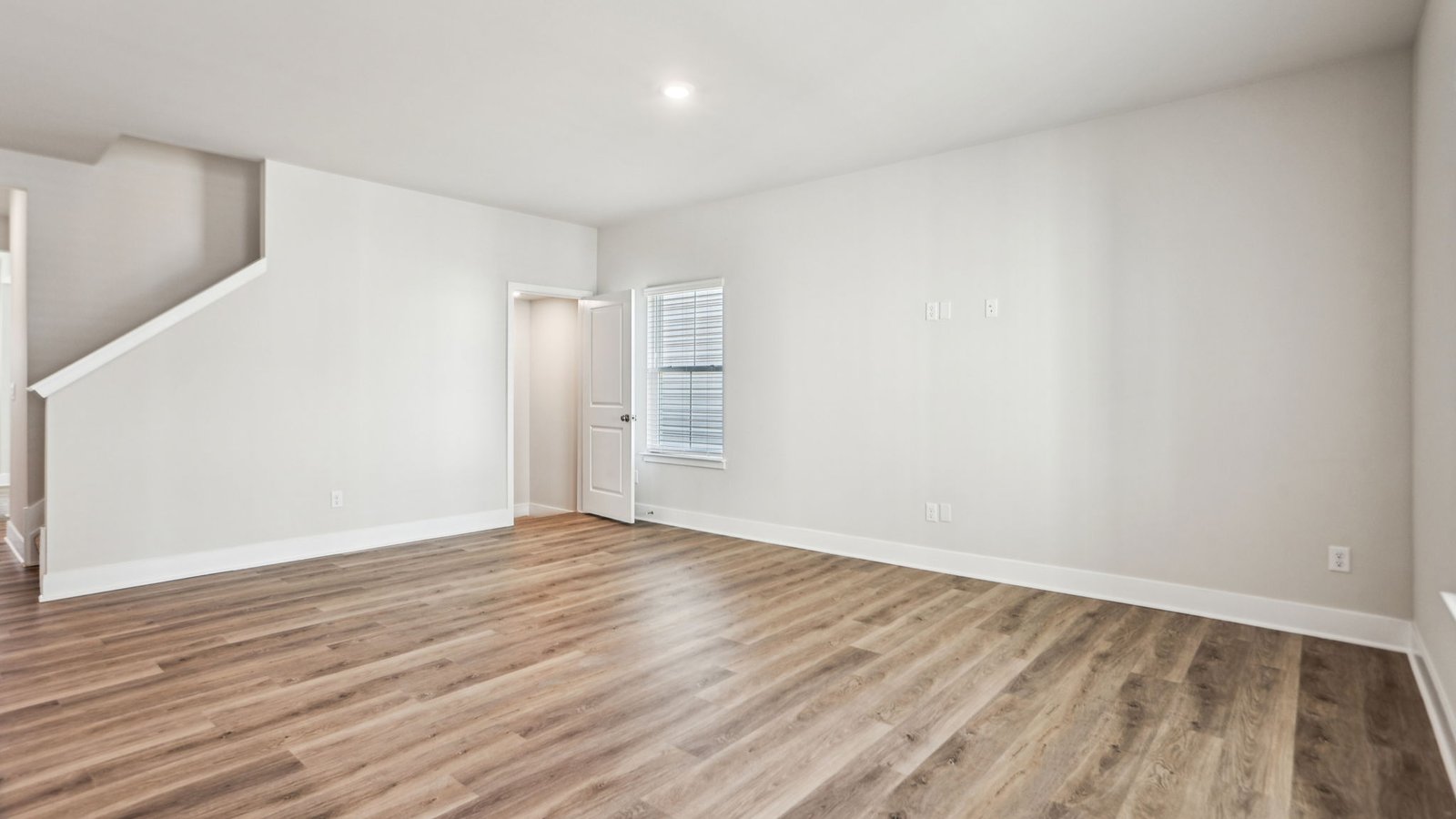 A door in the corner of the family room leads to the stairs