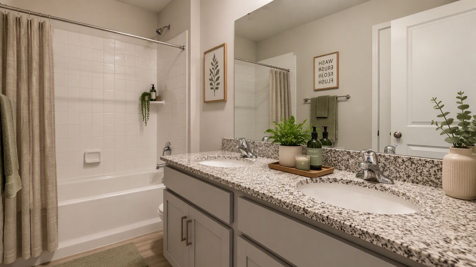 Full bathroom in a Winchester VA new construction home featuring dual-sink vanity, granite countertops, bathtub with shower, and modern finishes.