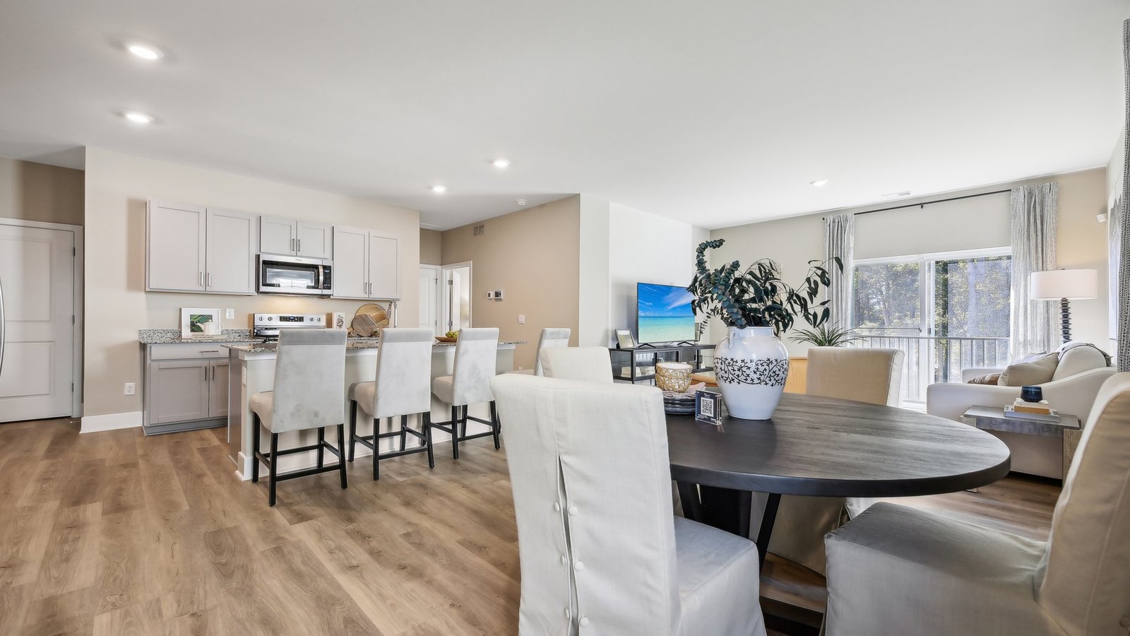 Open concept area combines kitchen, dining, and living spaces