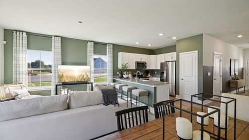 Dining table overlooks kitchen and living area