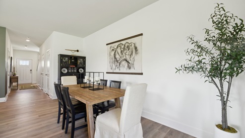 Dining table overlooks the front door and flyer
