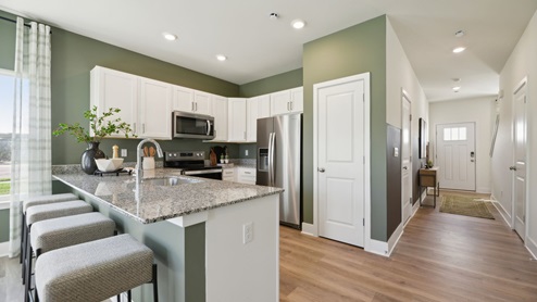 Come into the front door, walk through the foyer, and the kitchen will be on your right
