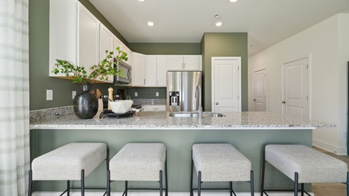 The other side of the kitchen counter sits up to 4 people