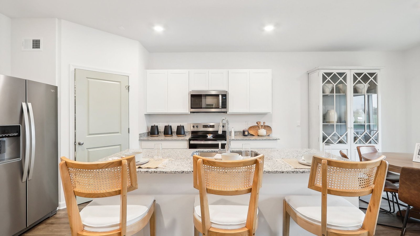 The kitchen is L-shaped with a large walk-in pantry in the corner