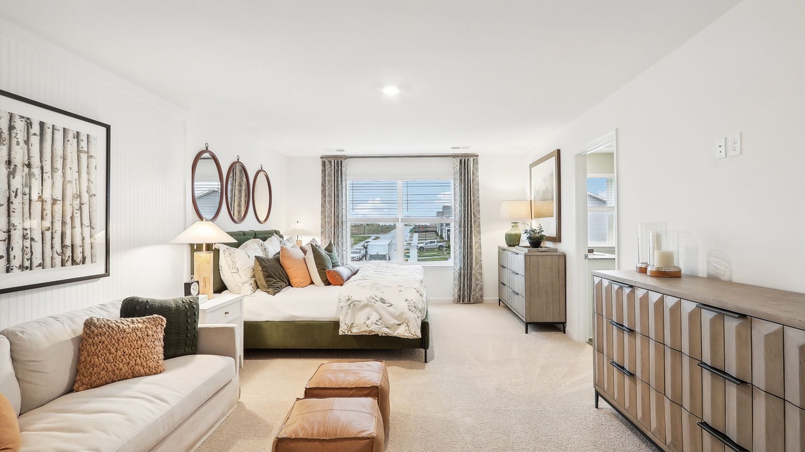 spacious primary bedroom comes with a cozy sitting area