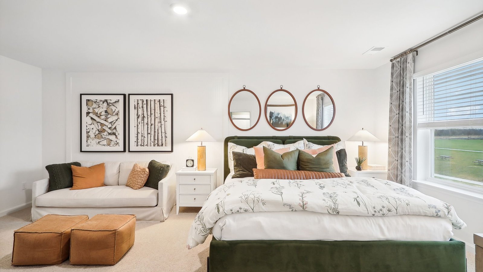 modern spacious primary bedroom with seating area