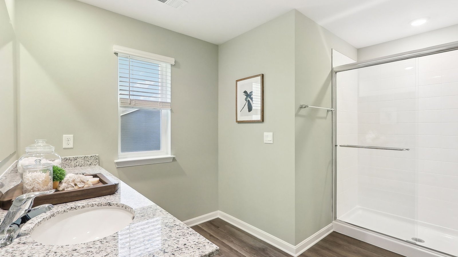 primary bath with double sink vanity and walk in shower