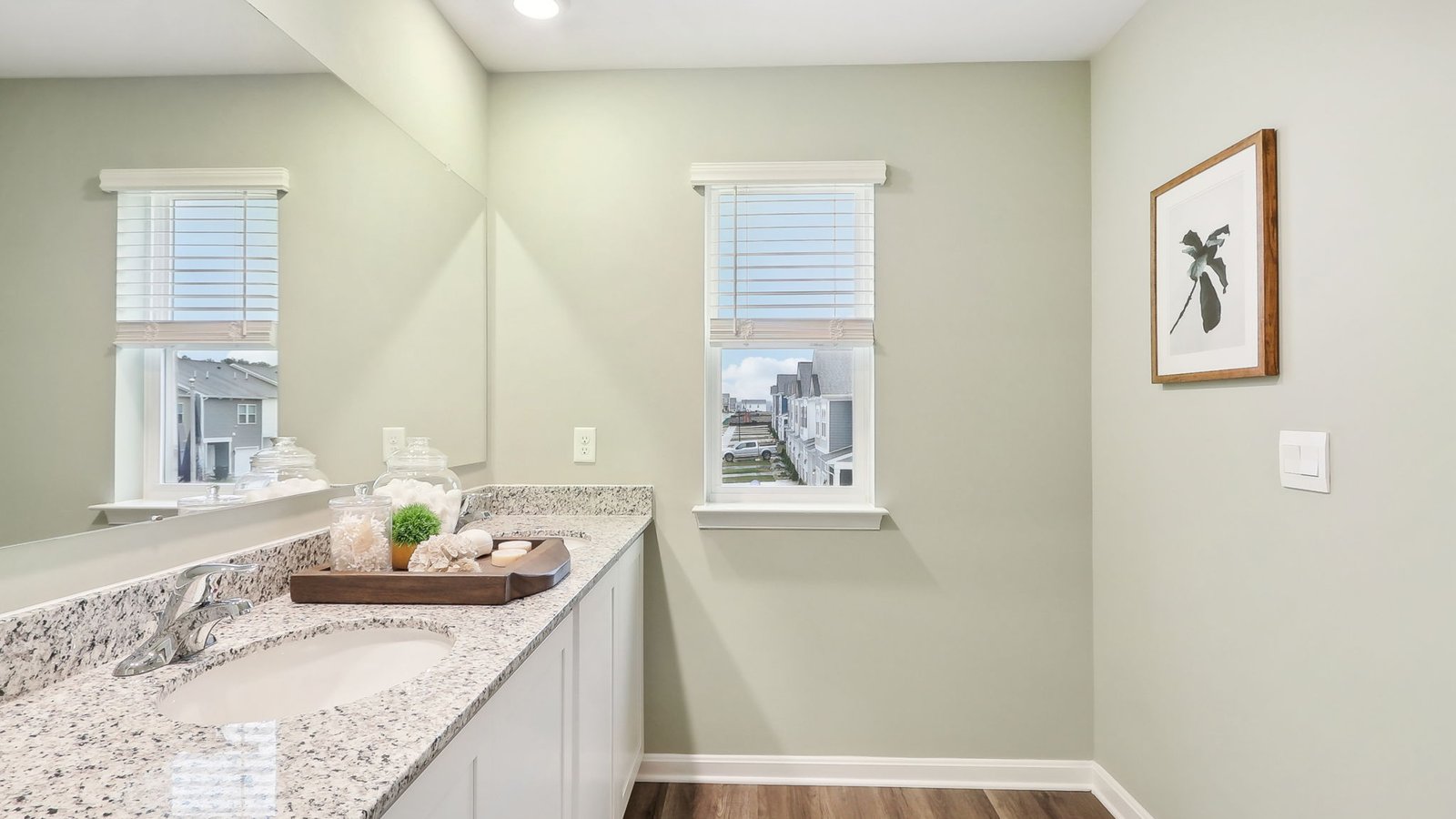 primary bath with double sink vanity and walk in shower