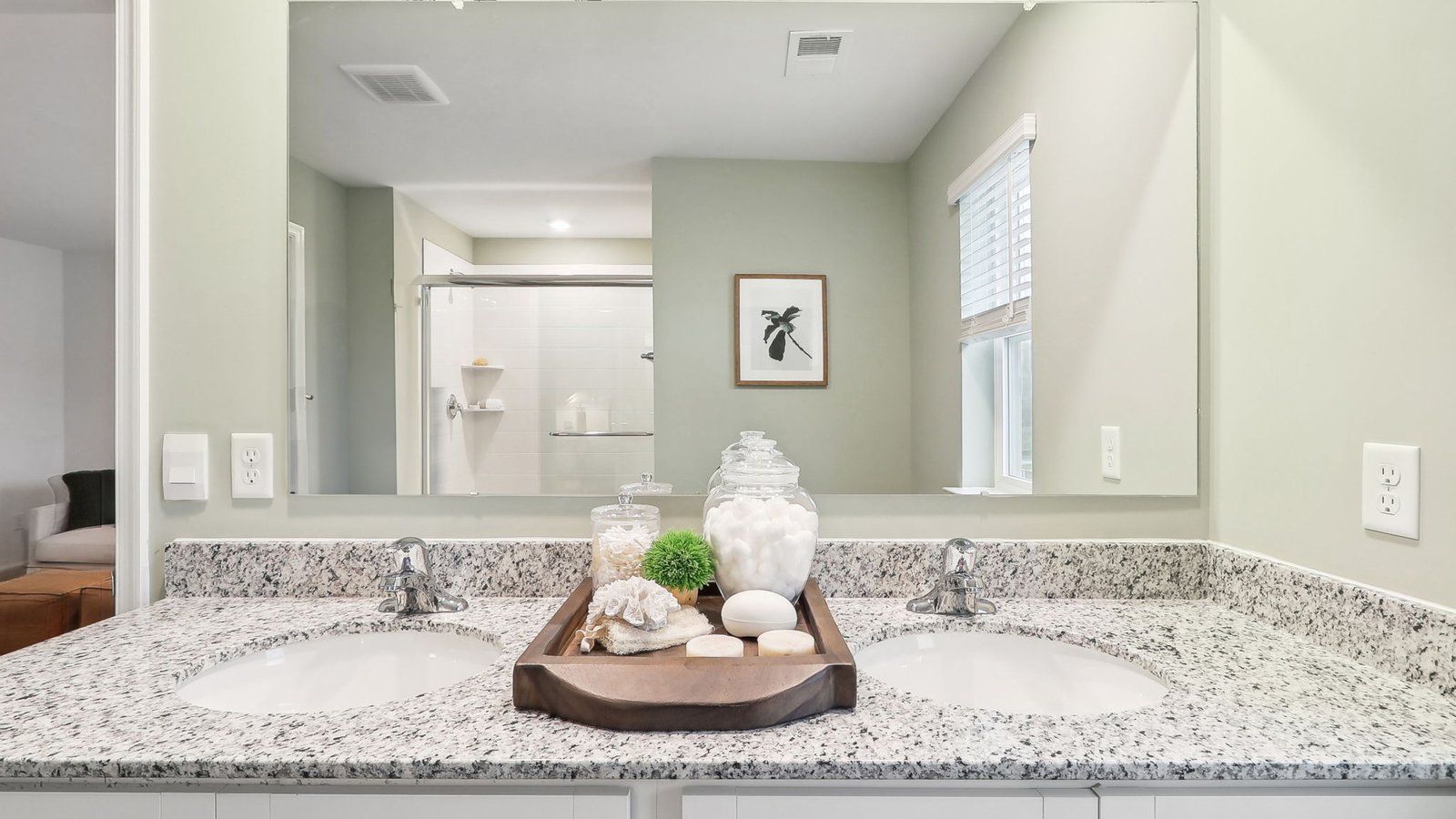 primary bath with double sink vanity and walk in shower