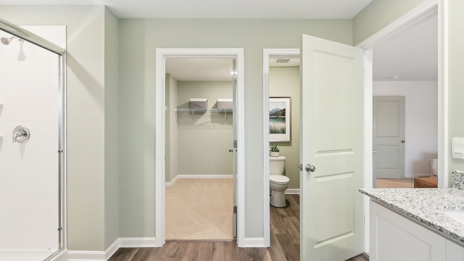 primary bath with double sink vanity and walk in shower