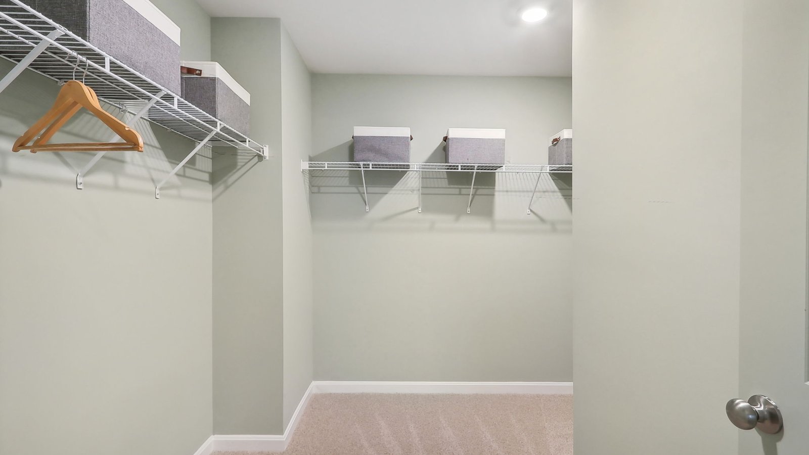 primary walk in closet with storage space