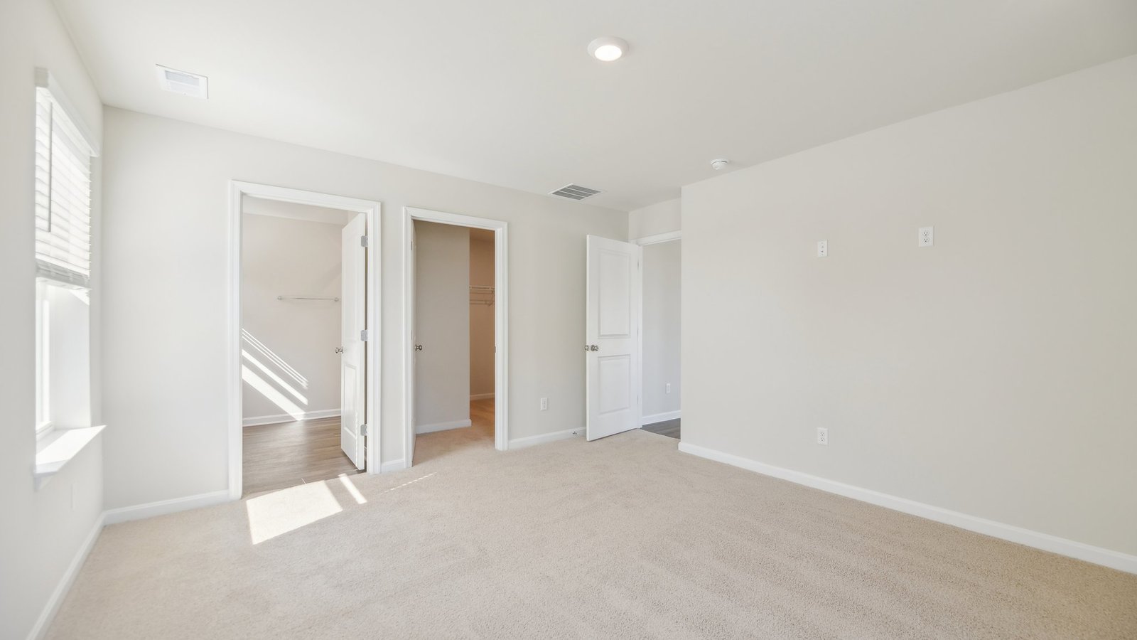 primary bedroom with lots of natural lighting