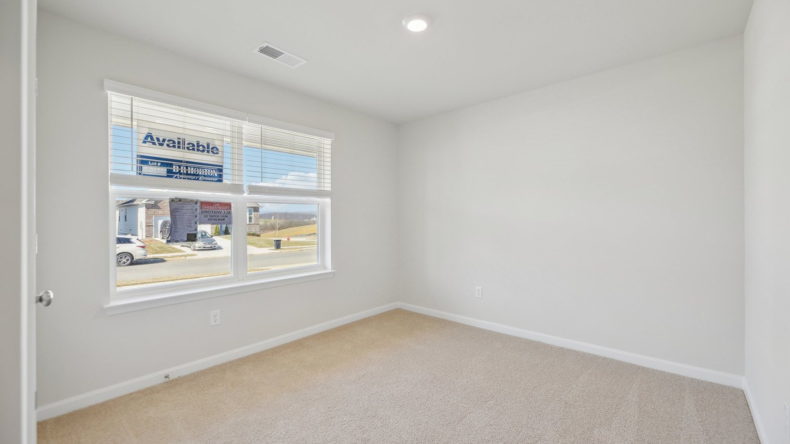 Secondary bedroom near the front of the house makes for a perfect office or hobby room