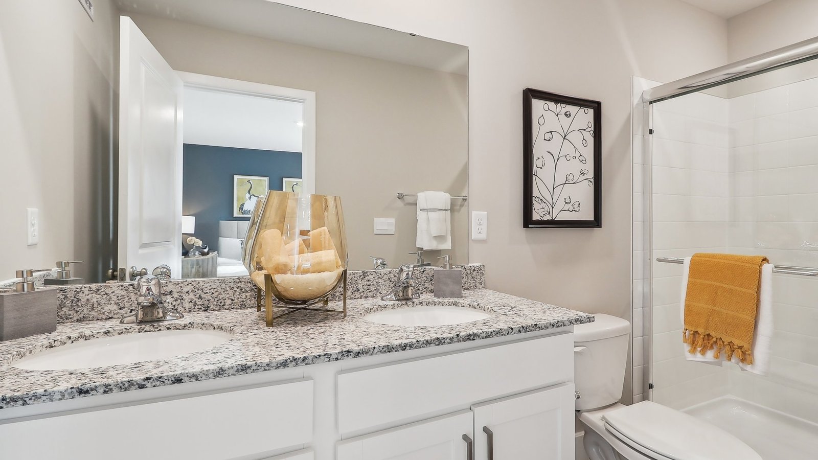 primary bathroom with dual sink vanity and walk in shower