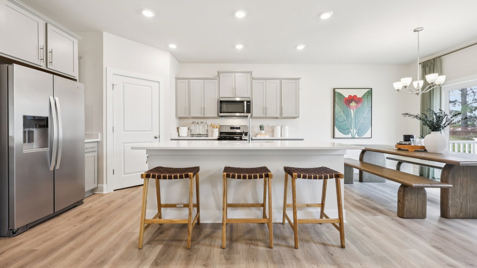 The kitchen features a large, modern island with 3 seats