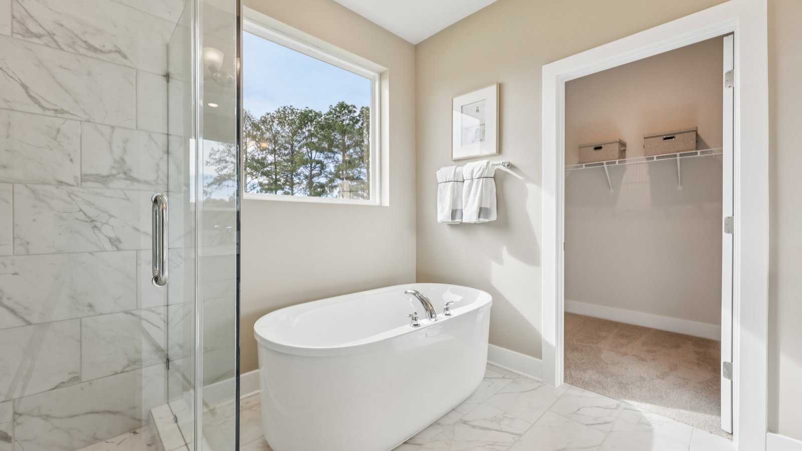 modern spacious primary bathroom with double sink vanity and walk in shower and soaking tub