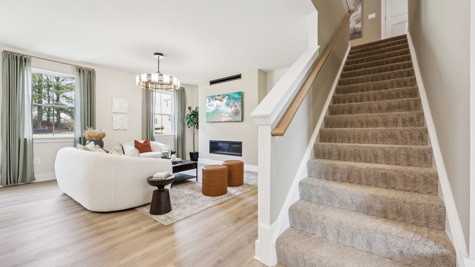 Open concept main floor living with stairs leading up