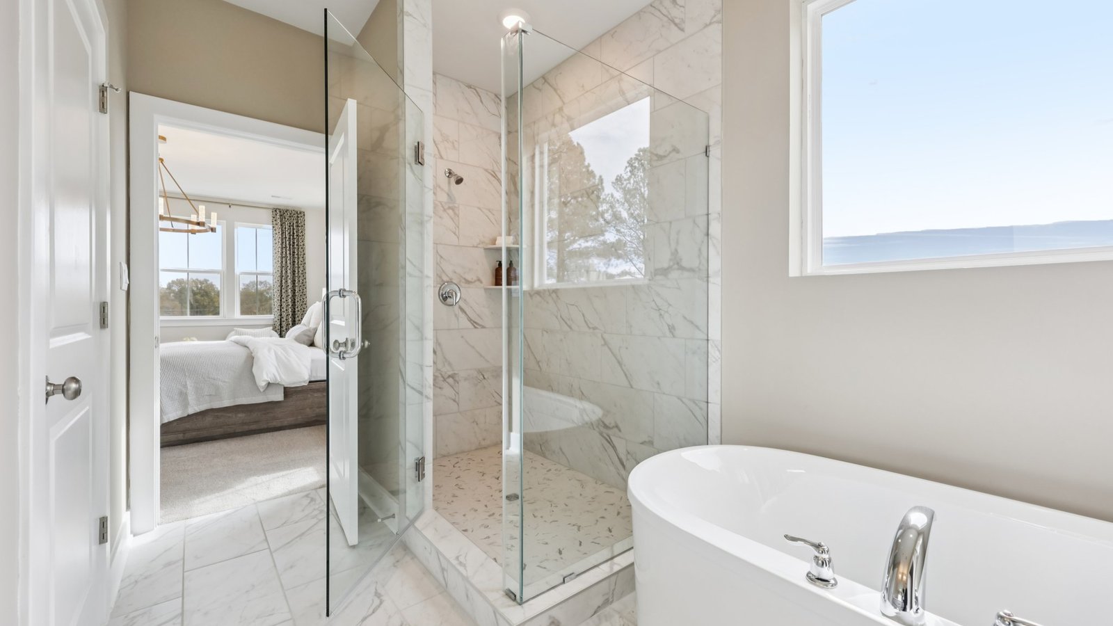 modern spacious primary bathroom with double sink vanity and walk in shower and soaking tub