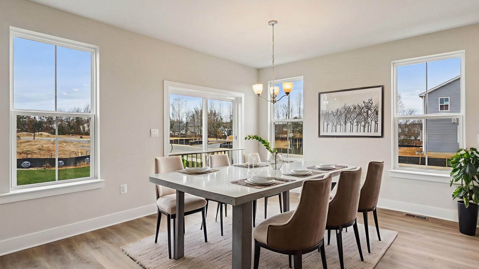 Open dining area in a new construction home in Fredericksburg, Virginia featuring seamless flow between the kitchen and living spaces.