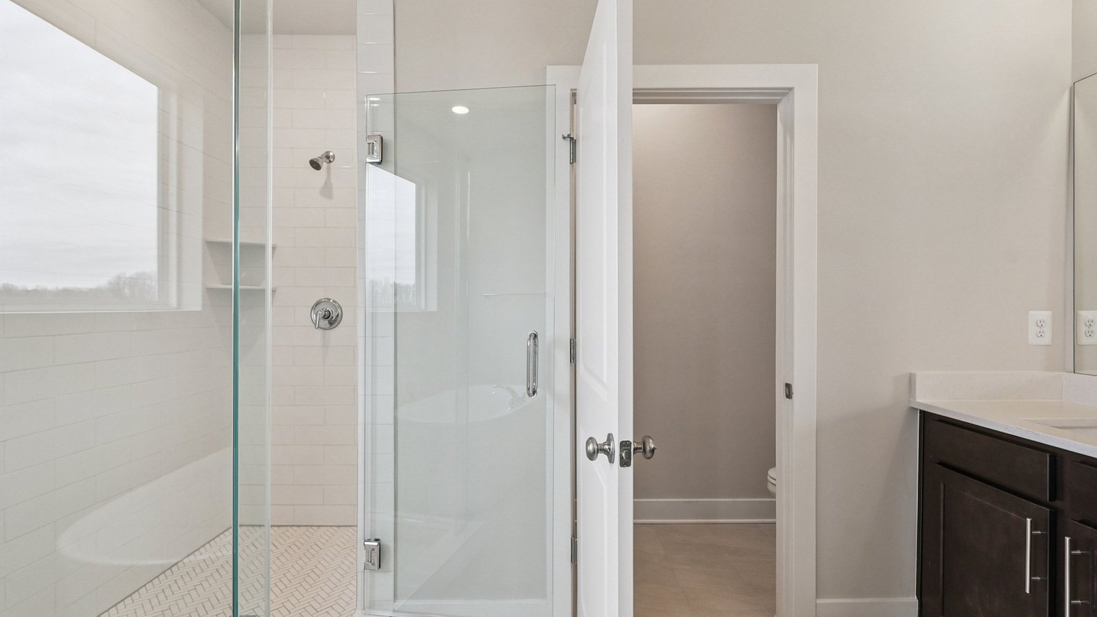 primary bathroom with double sink vanity and walk in shower and soaking tub