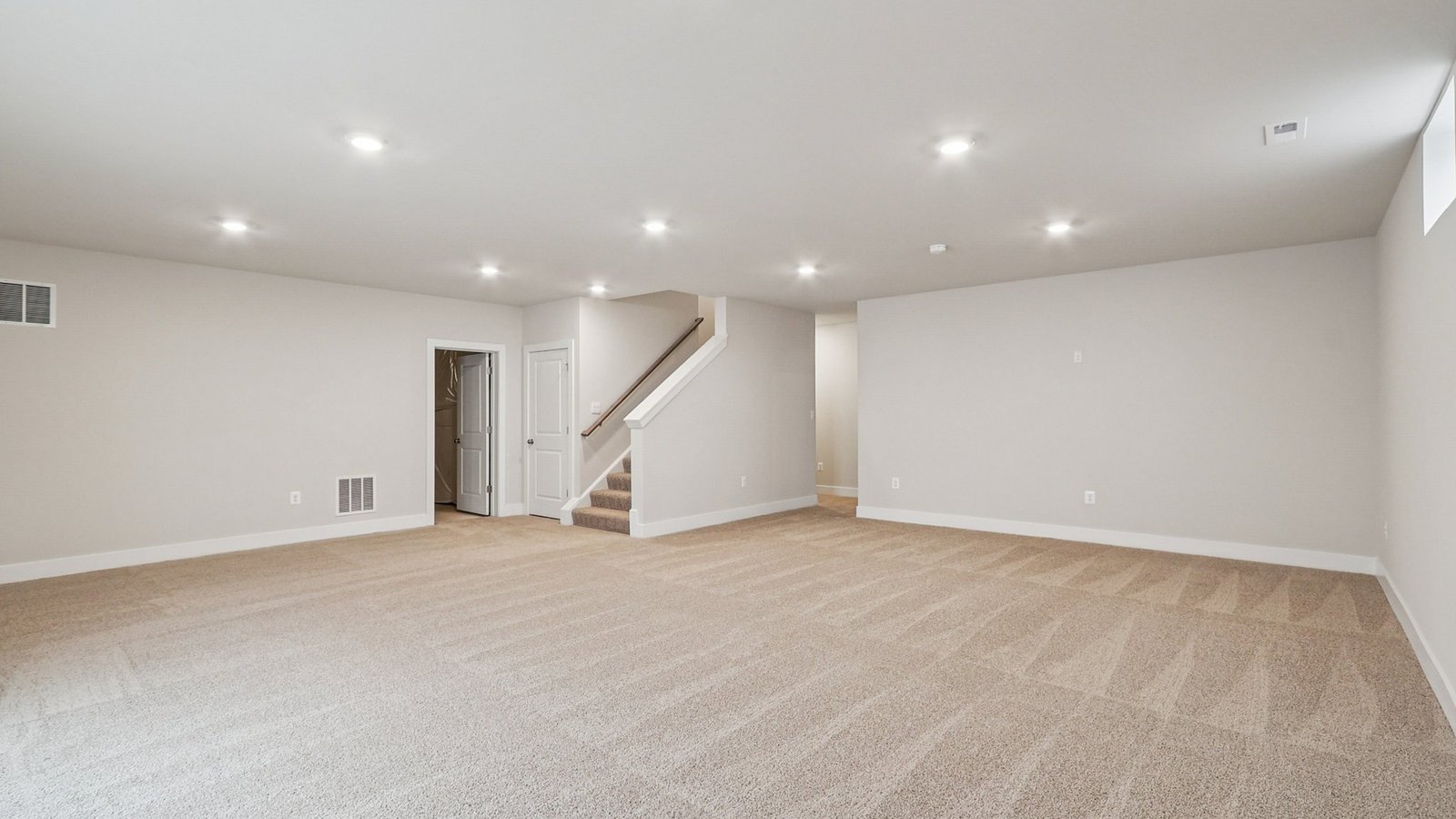 Rec room in a basement with stairs