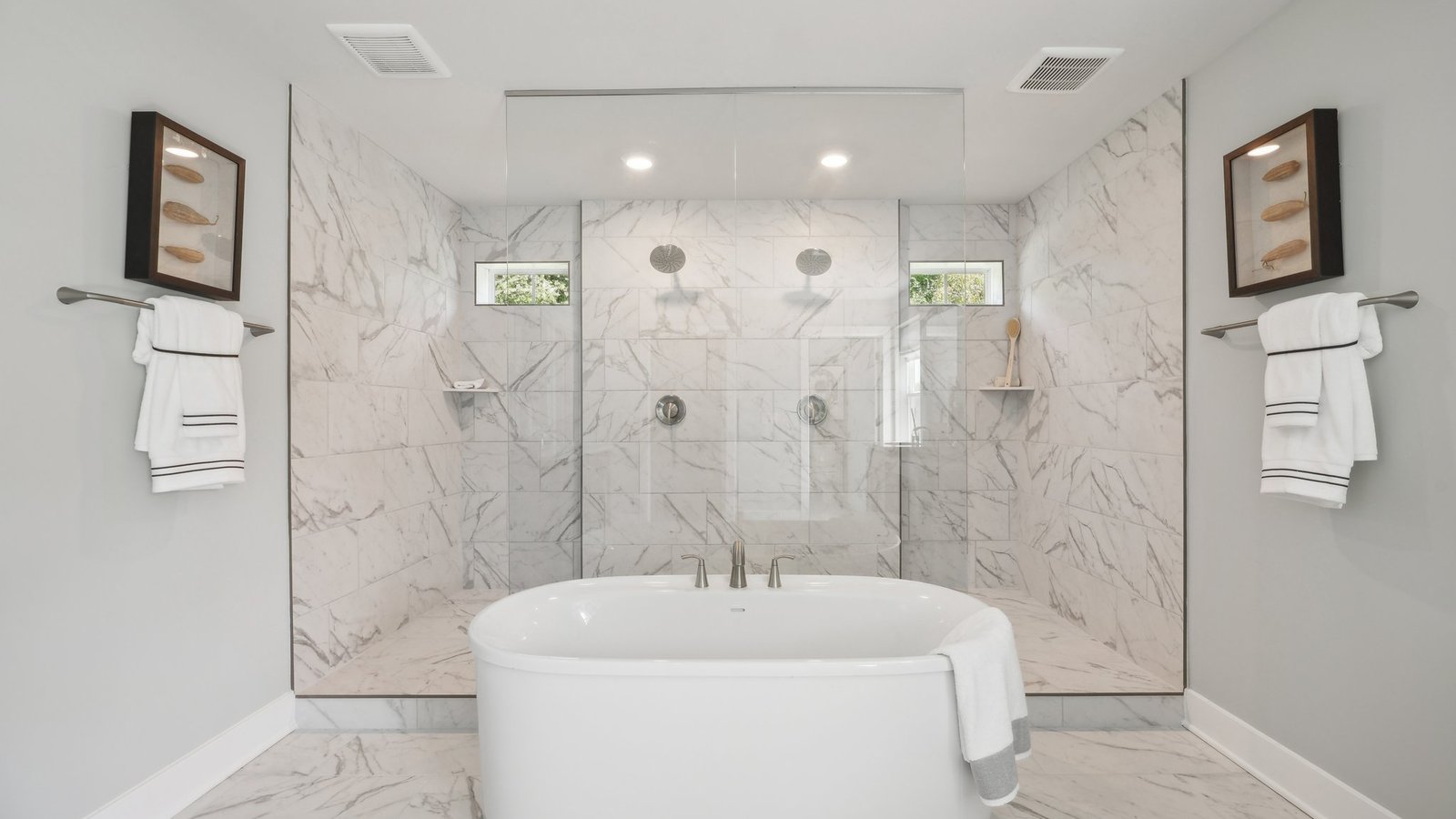 primary full bathroom with separate vanities walk in shower and soaking tub