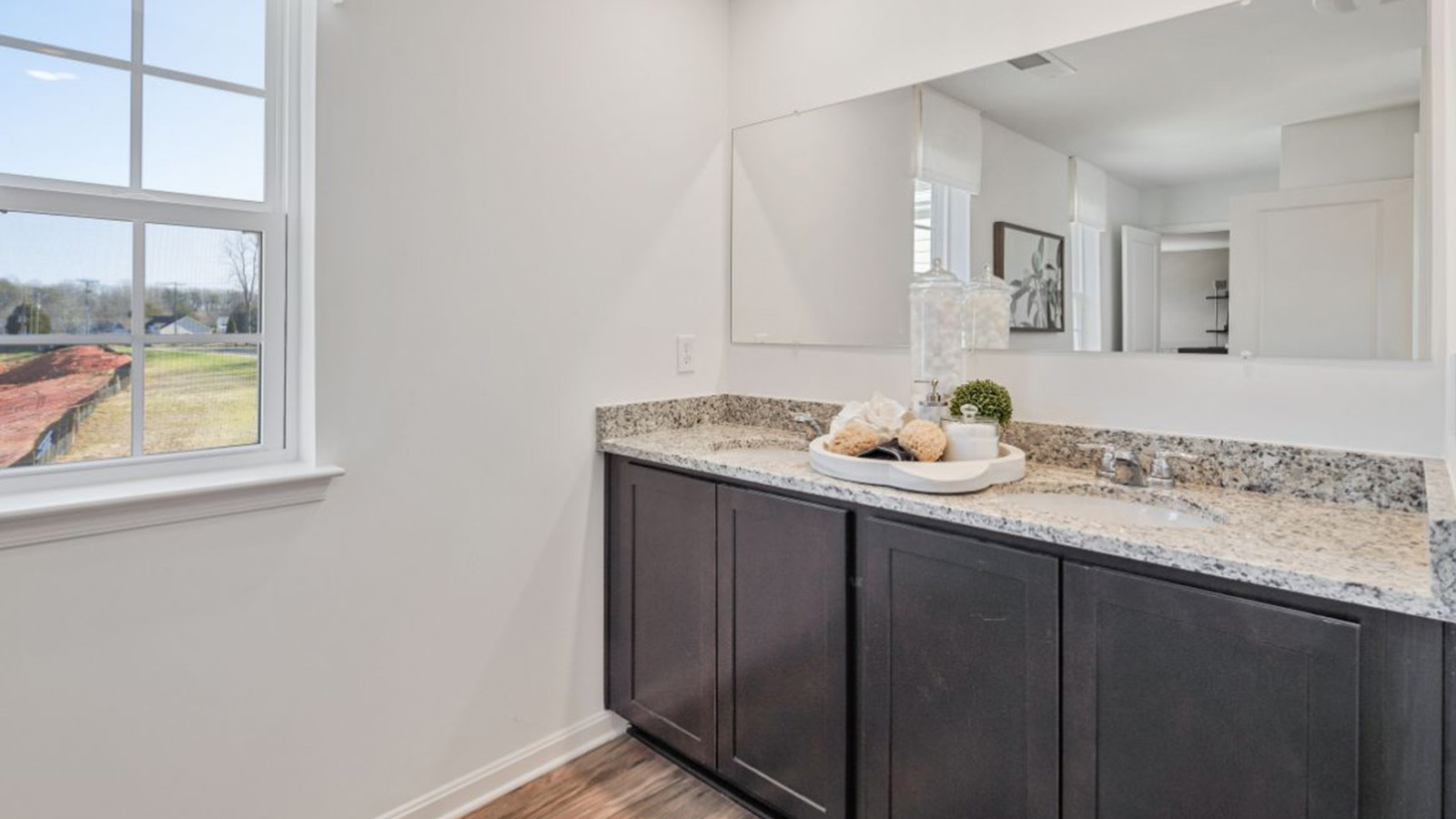 full primary bathroom with double sink vanity and walk in shower
