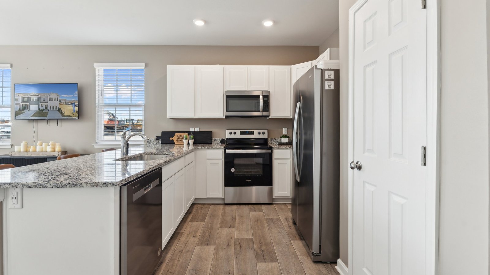 U-shaped kitchen with granite countertops