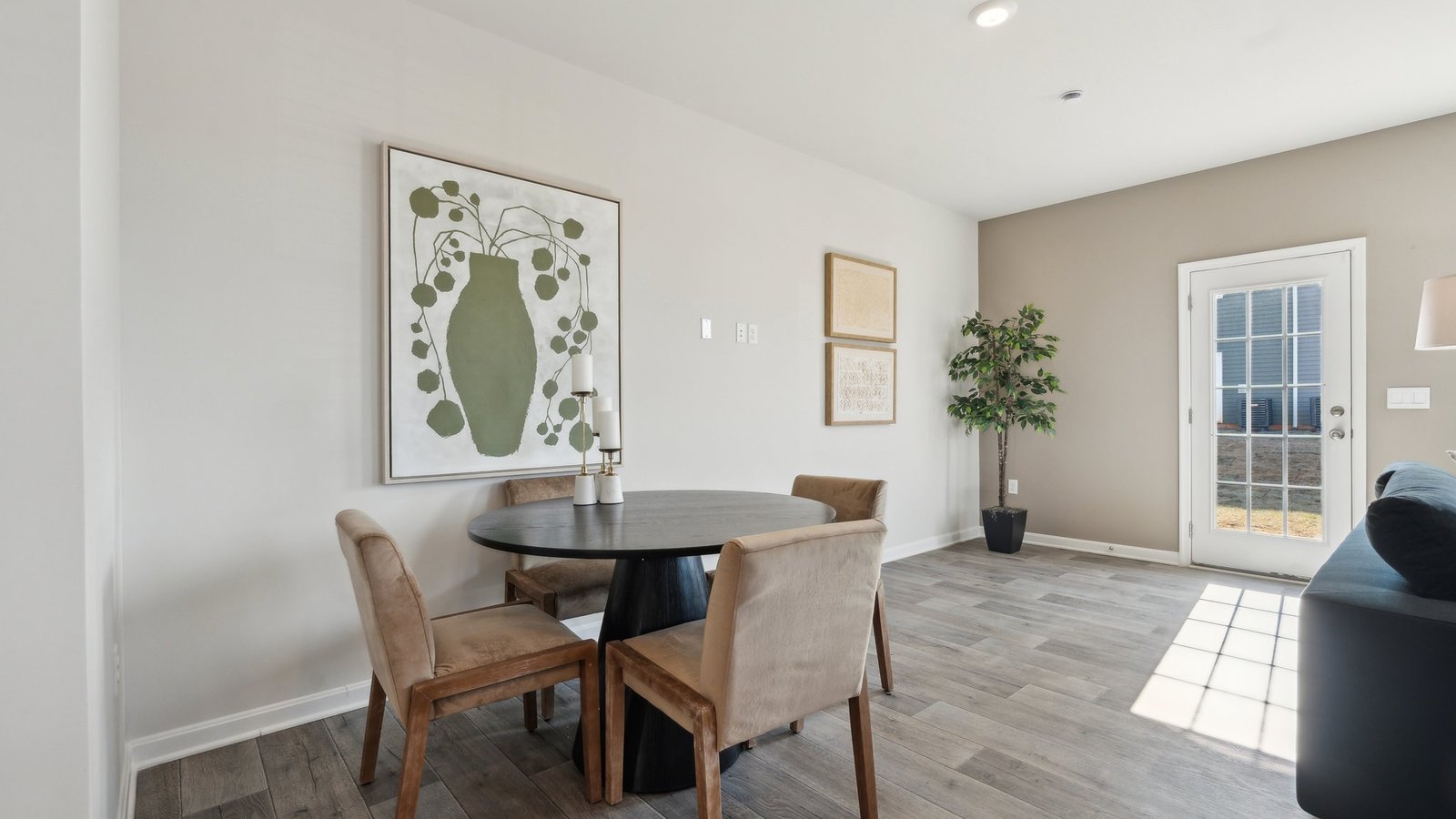 A dining table is situated across from the kitchen