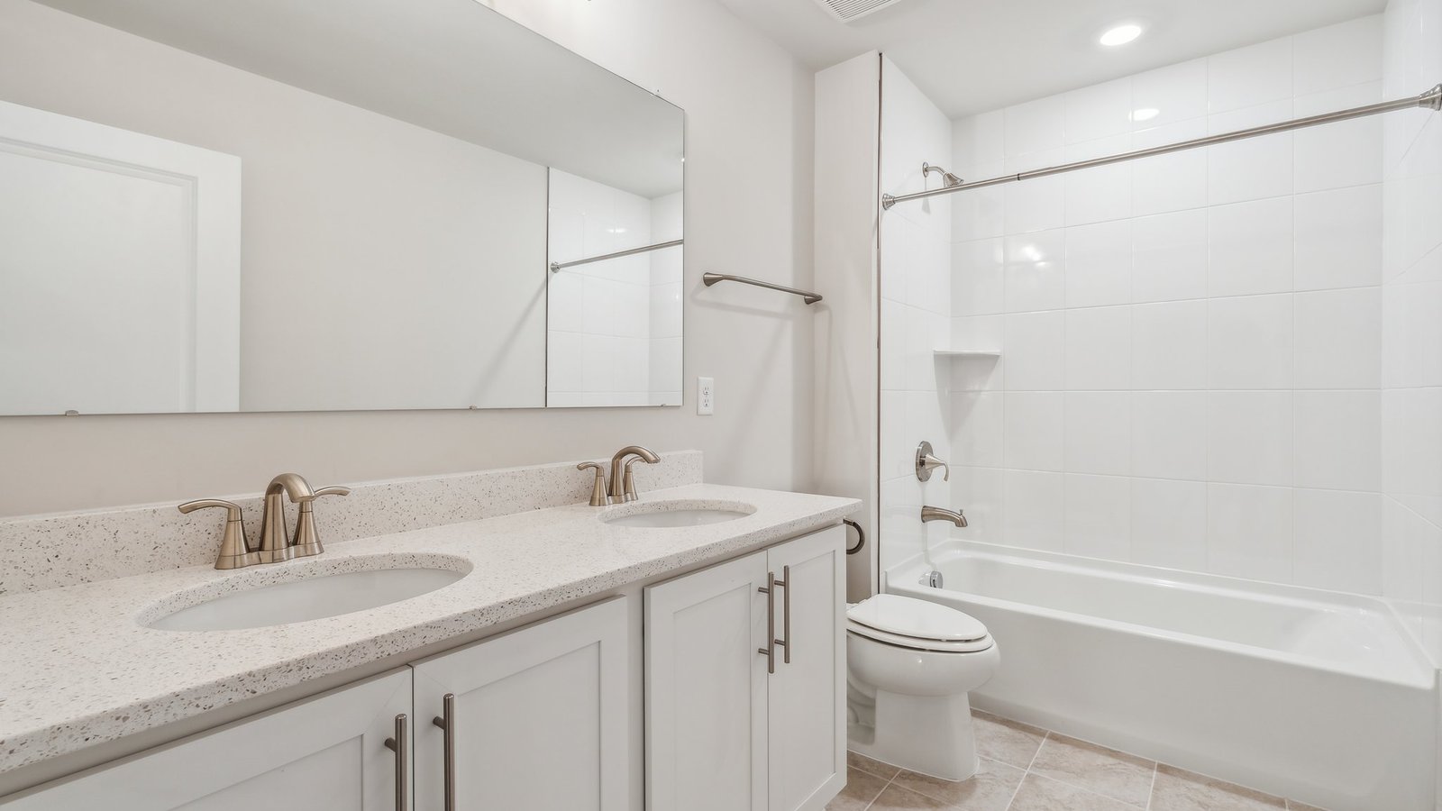bathroom with a double vanity and a bathtub