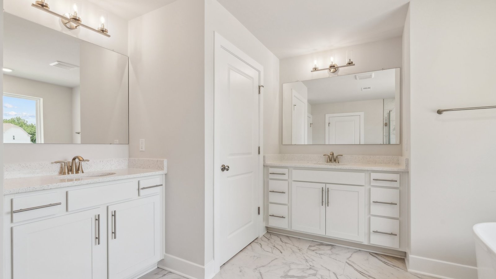 2 separate vanities in the primary bathroom