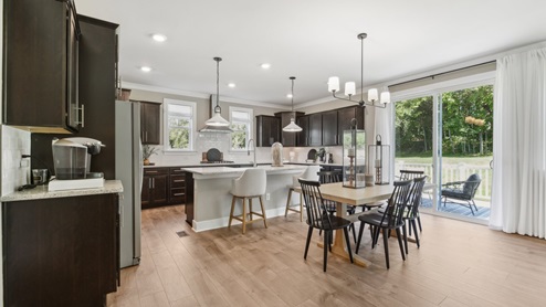 casual dining overlooks the patio doors and has a view of the backyard