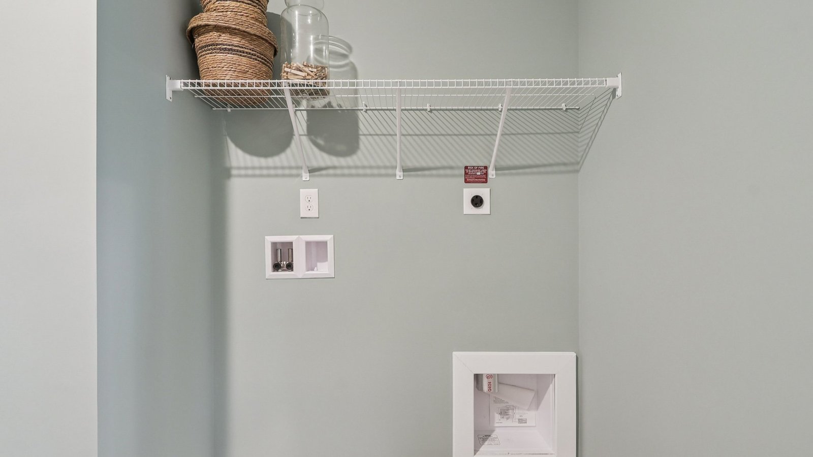 laundry area with storage shelves