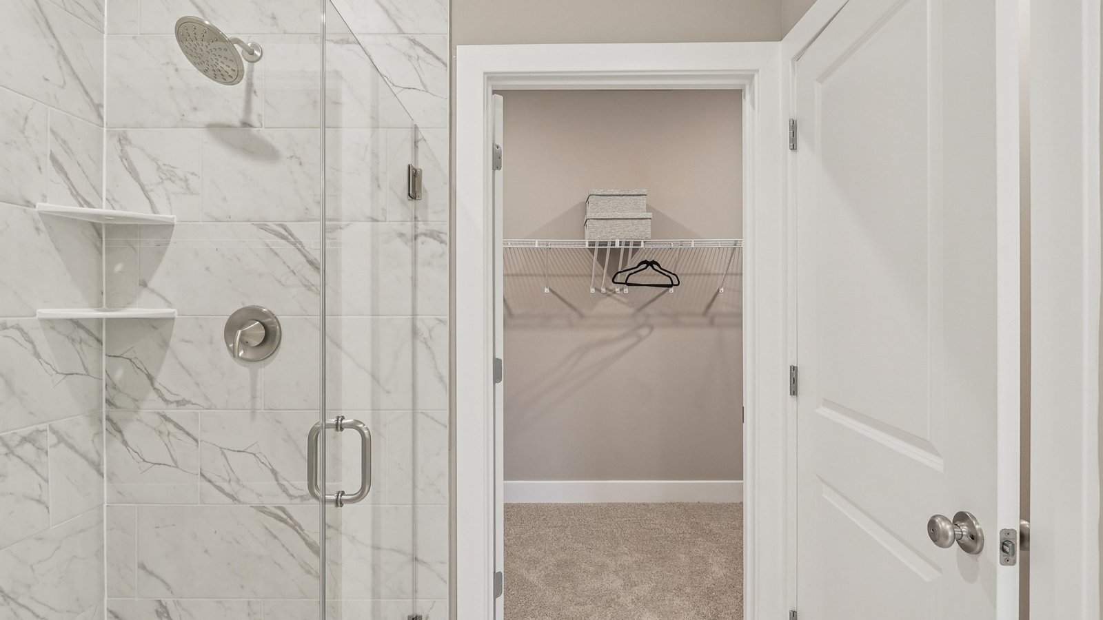 primary full bathroom with double sink vanity, walk in shower, and and modern design