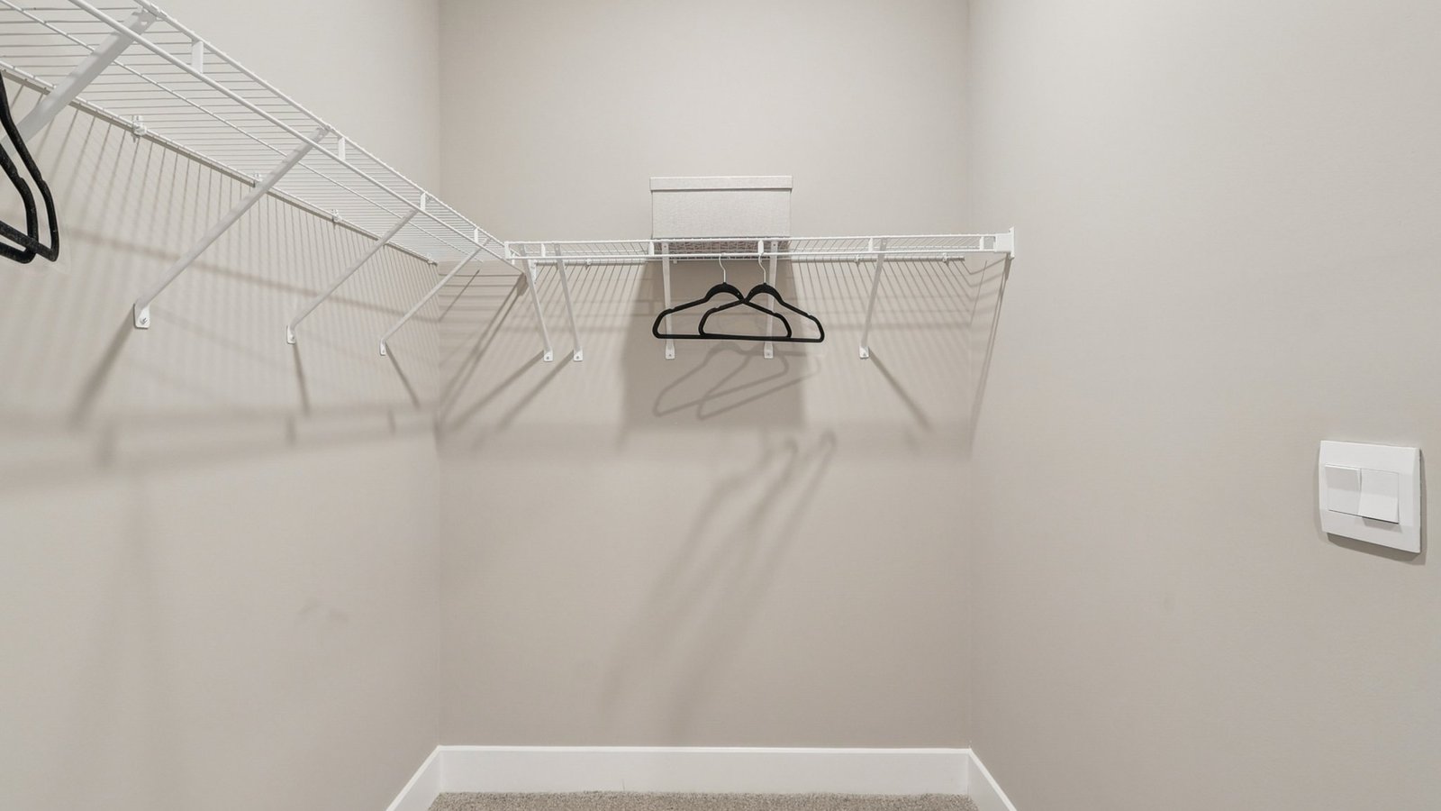 primary walk in closet with storage shelves