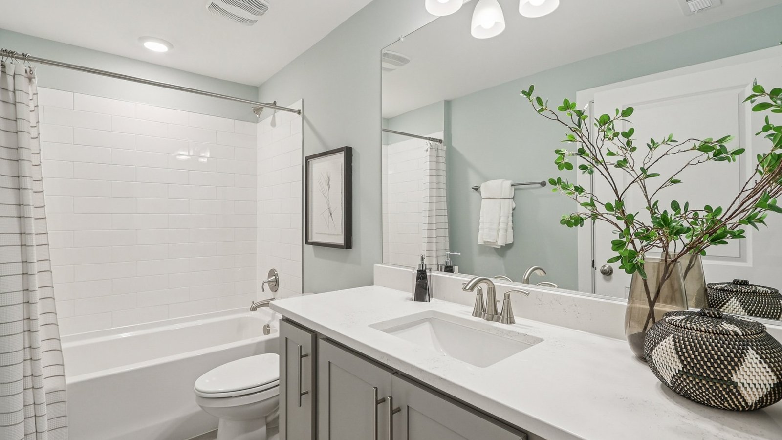 basement full bathroom with  dual sink vanity