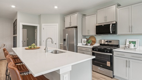 Breakfast island comes with a sink and dishwasher perfect for prepping food and cleaning