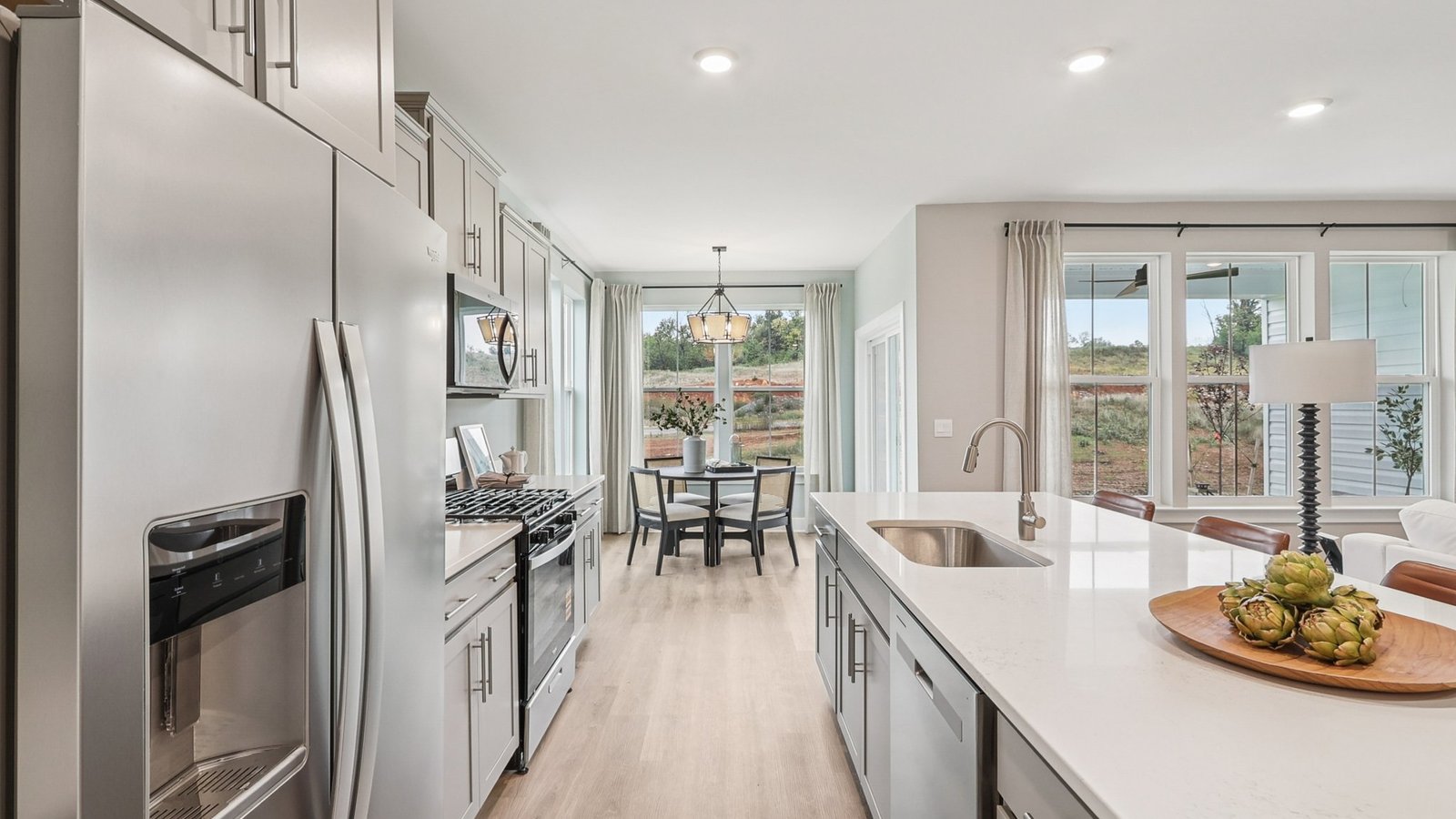 Kitchen island overlooks dining, living, and breakfast area