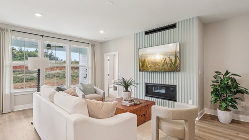 Living room has large windows which let in a lot of natural light