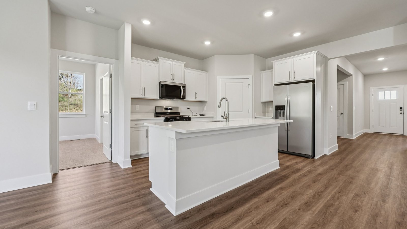 Just outside the kitchen is a bedroom entrance