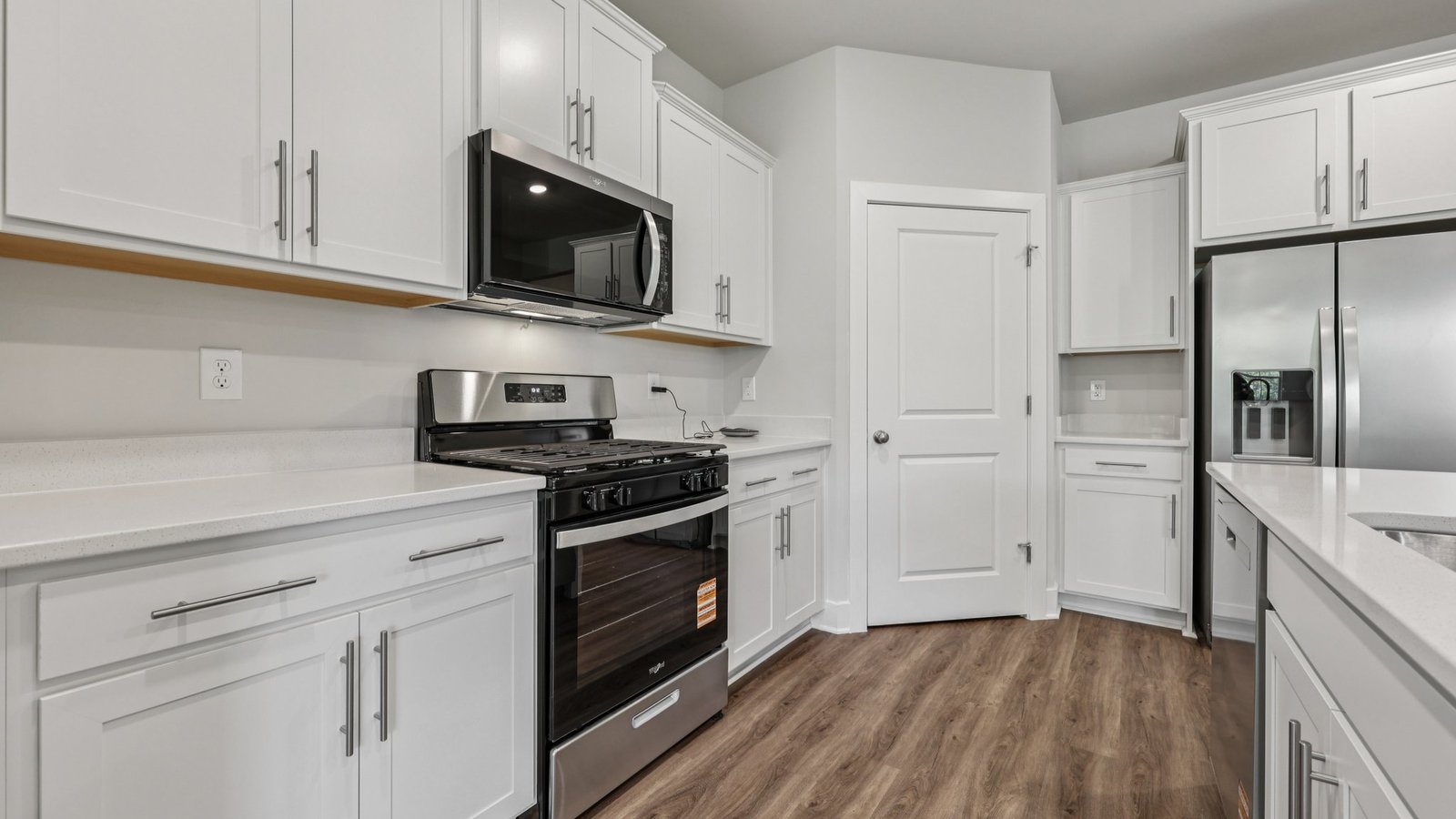 The kitchen features a large corner pantry