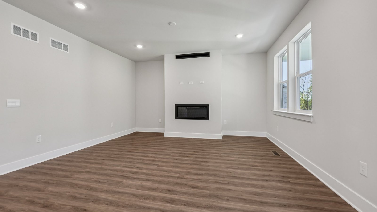 open concept living room with fireplace and modern design