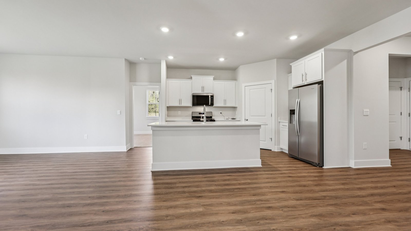 open concept kitchen with white cabients and modern design