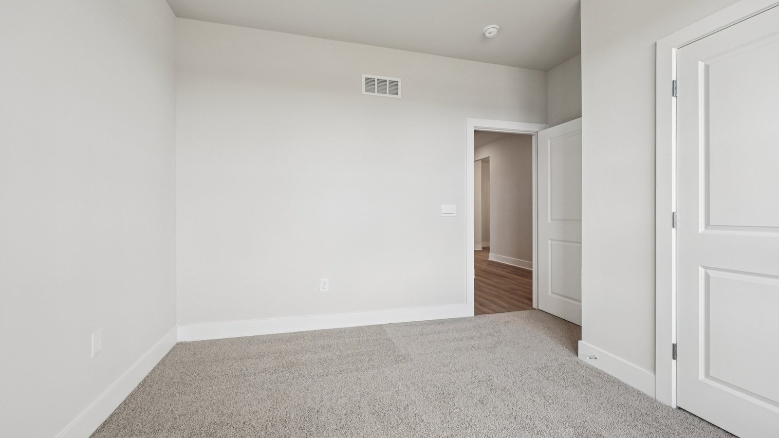 Secondary bedroom on the main floor overlooking the front yard