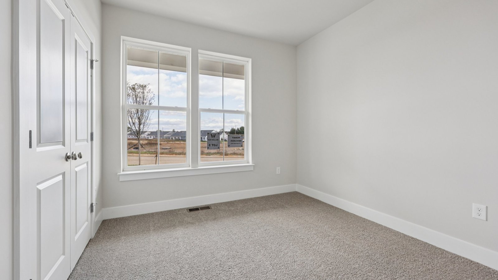 Secondary bedroom on the main floor overlooking the front yard