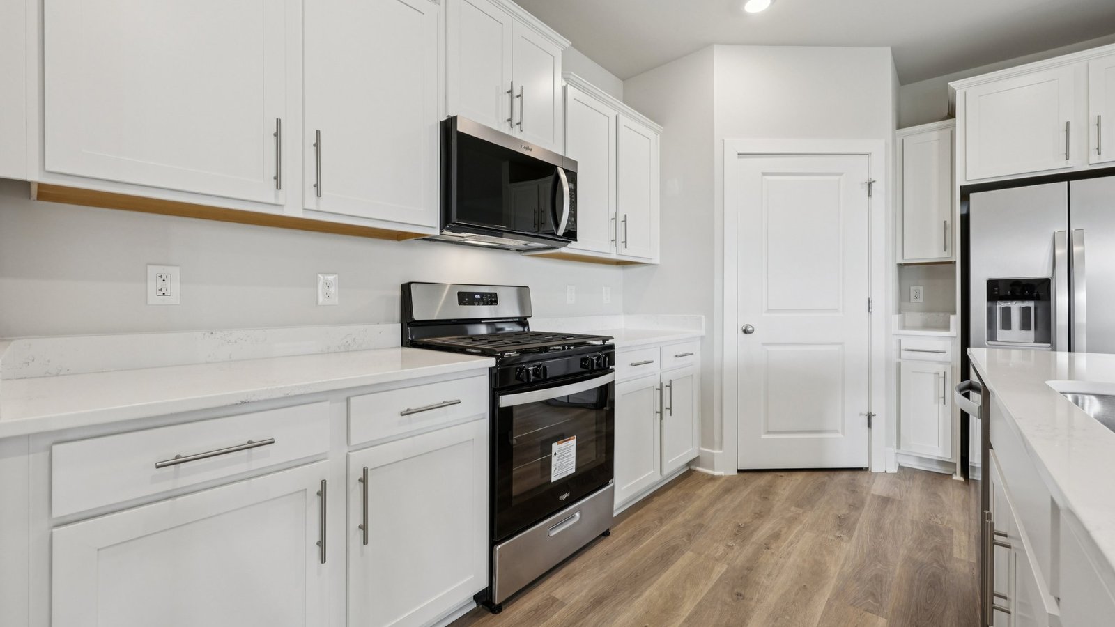 modern open concept kitchen with white cabinets