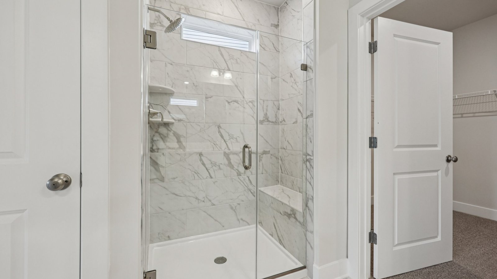 double sink vanity in primary bathroom with walk in shower